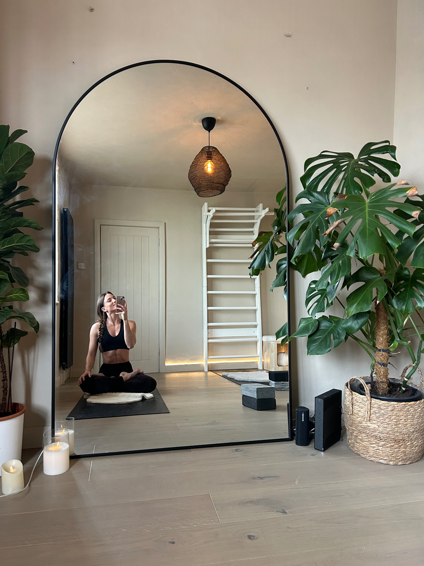 Helen in her home studio with mirror, plants and candles